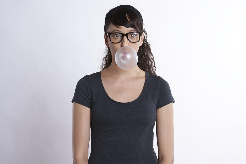 Woman blowing bubblegum bubbles