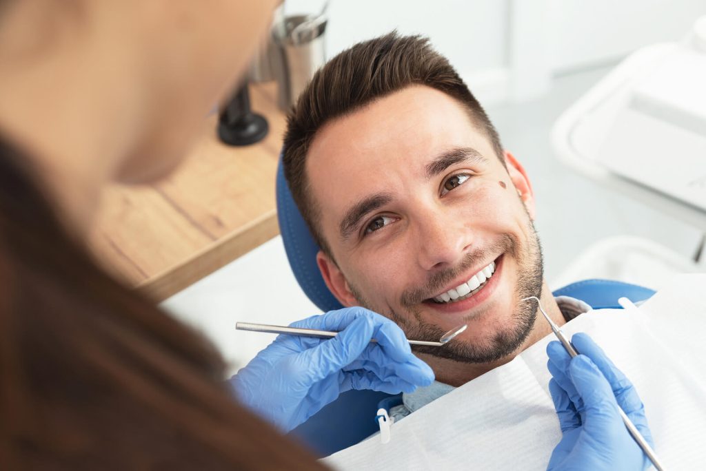 A Man Having A Visit At The Dentist's