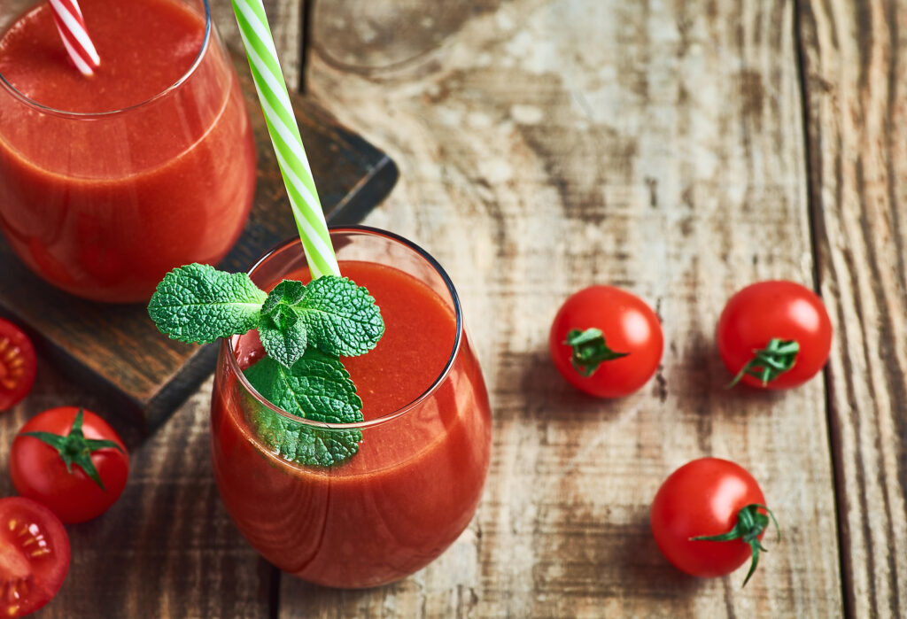 Fresh healthy red tomato juice served in glass  for diet and detox.Tomato juice detox. Red tomato juice detox diet. Diet tomato vegetable juice. Red tpmato juice. Red detox diet juice. Red vegie tomato juice detox.