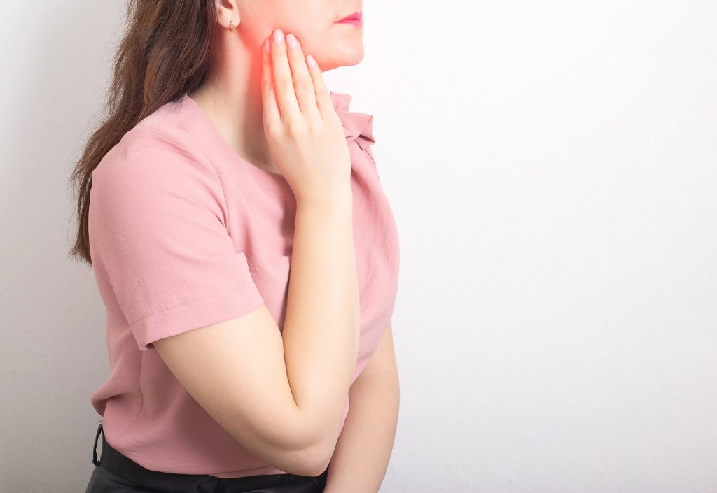 A Brunette Girl Holds With Her Hand The Jaw Of A Sick Wisdom Too